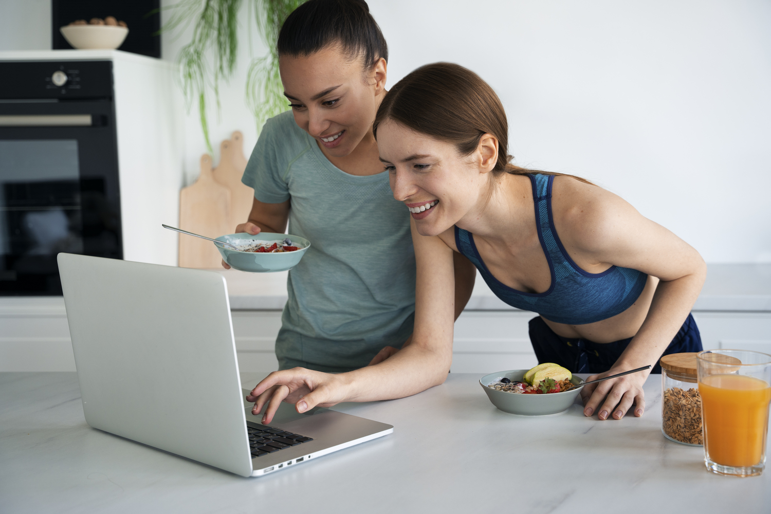 side view smiley women with laptop at Core Concept